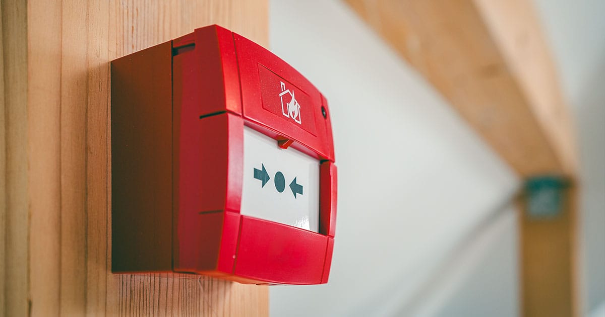 Manual call point on wooden beam