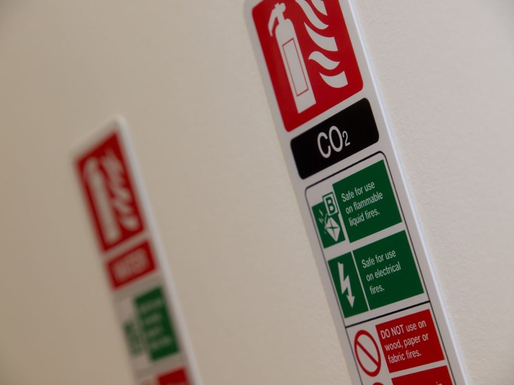 CO2 fire extinguisher sign on white wall