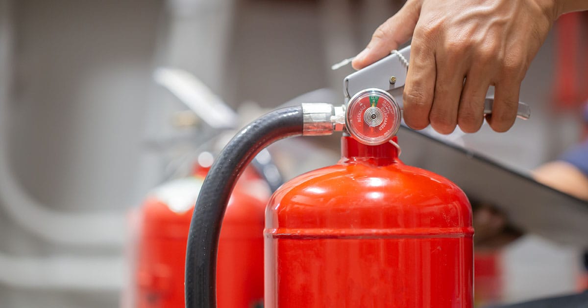 Person holding fire extinguisher