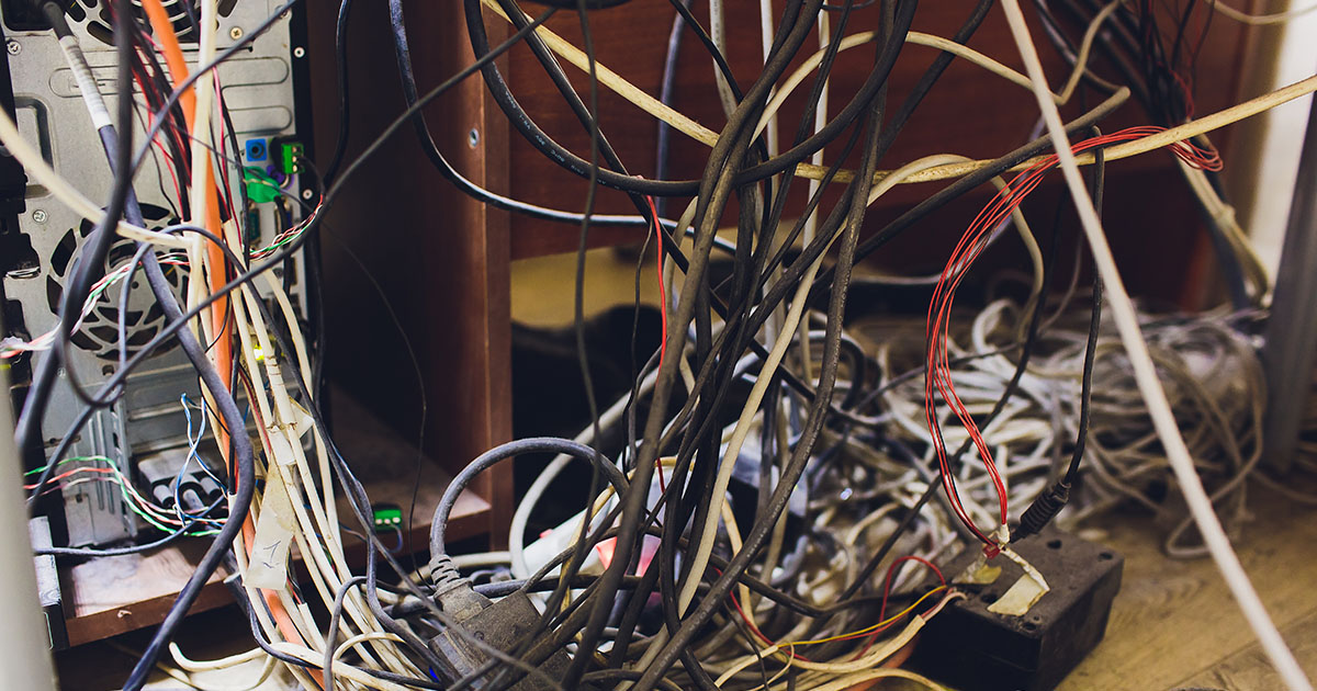 Messy tangled cables under desk