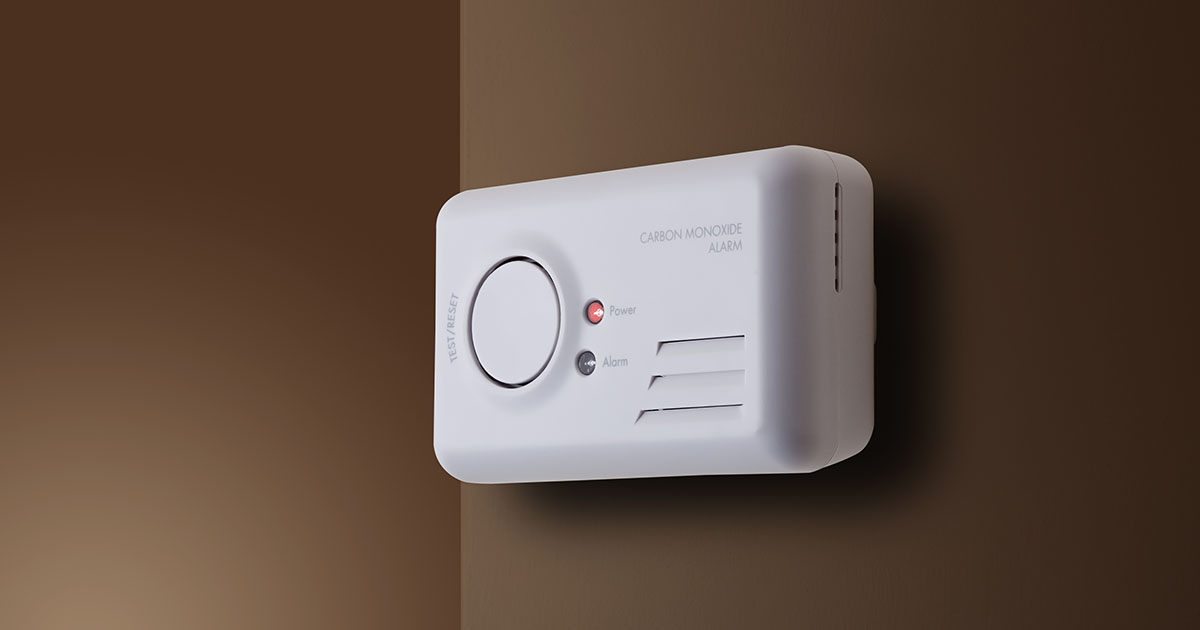 Carbon monoxide alarm on brown wall
