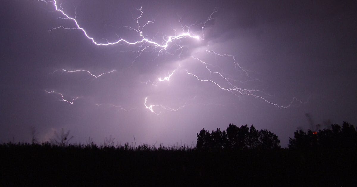 Purple lightning over field