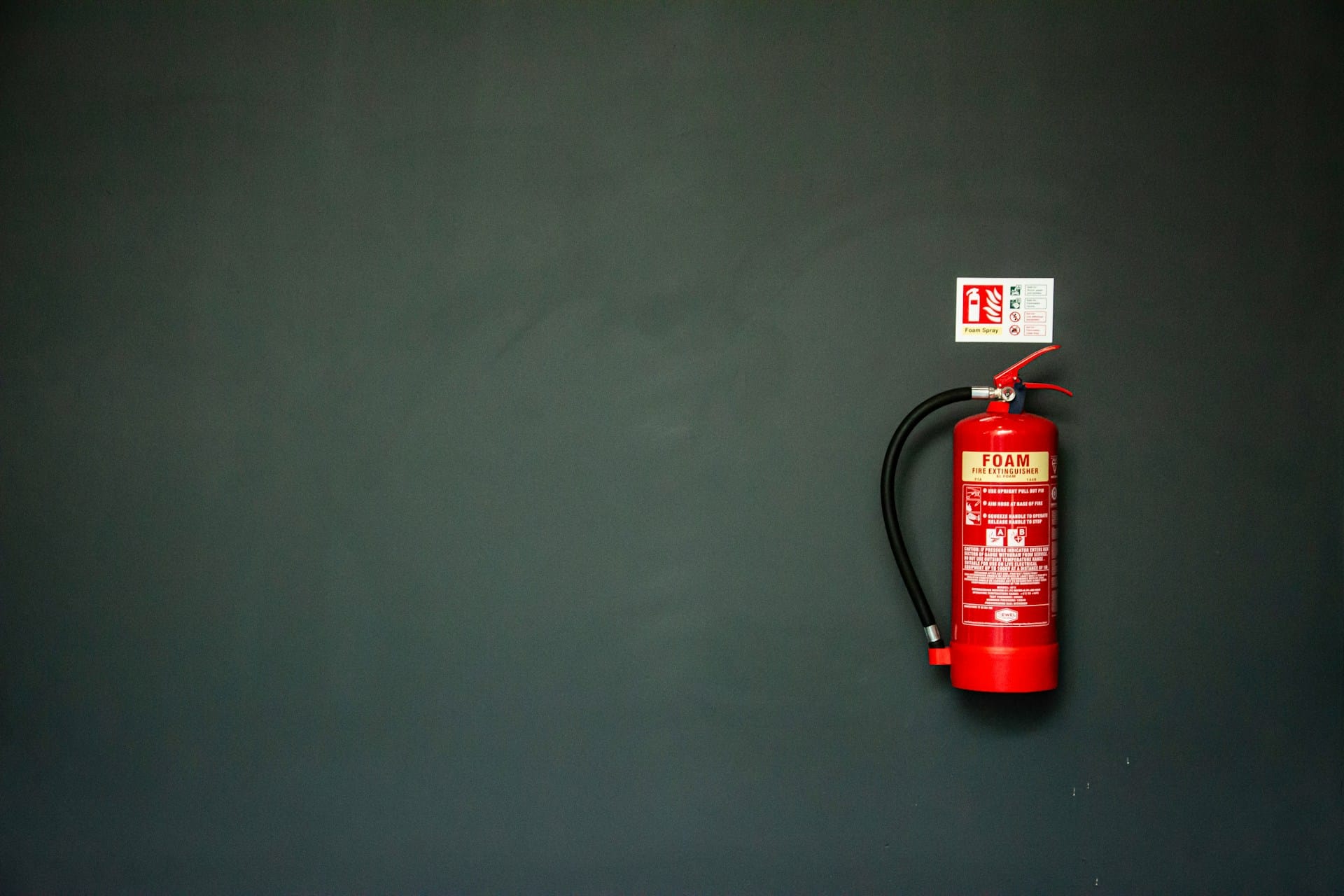 A foam fire extinguisher attached to a wall in a business premises