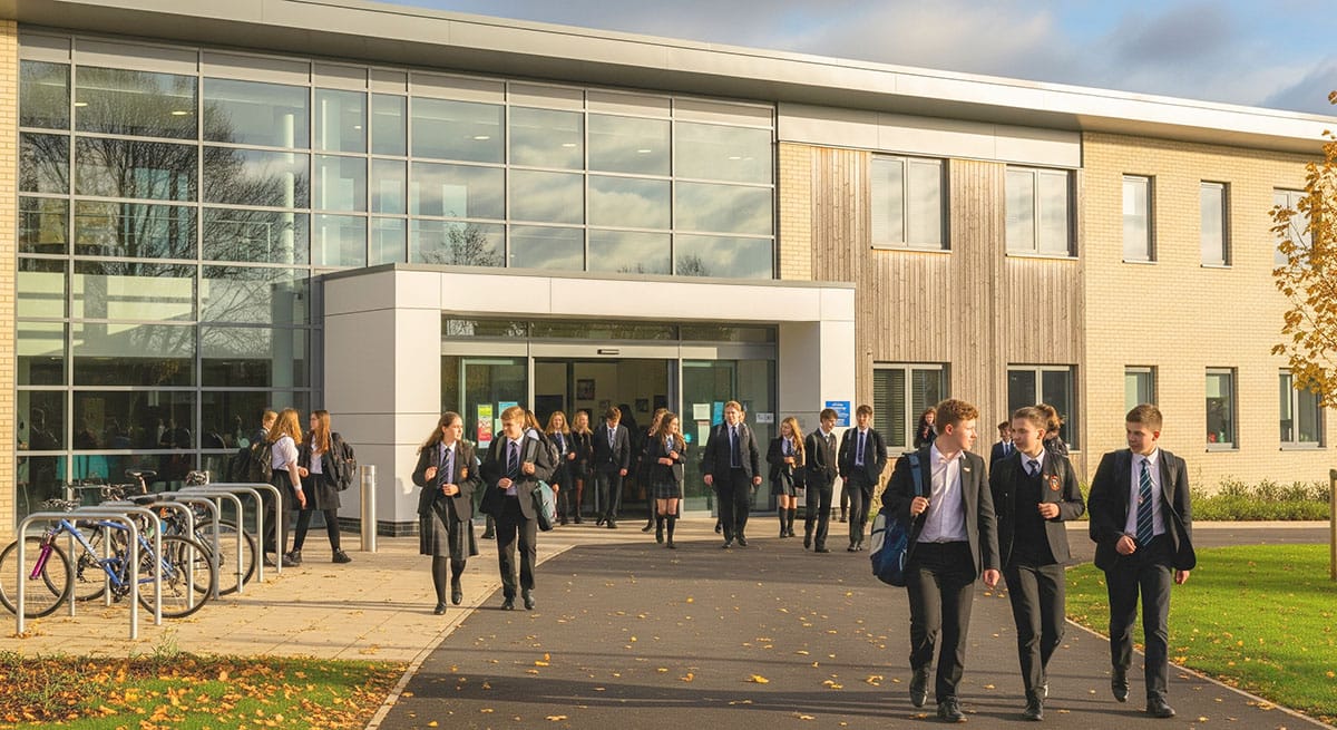 An English comprehensive school where pupils are exiting a building. Martyn’s Law applies to most educational establishments