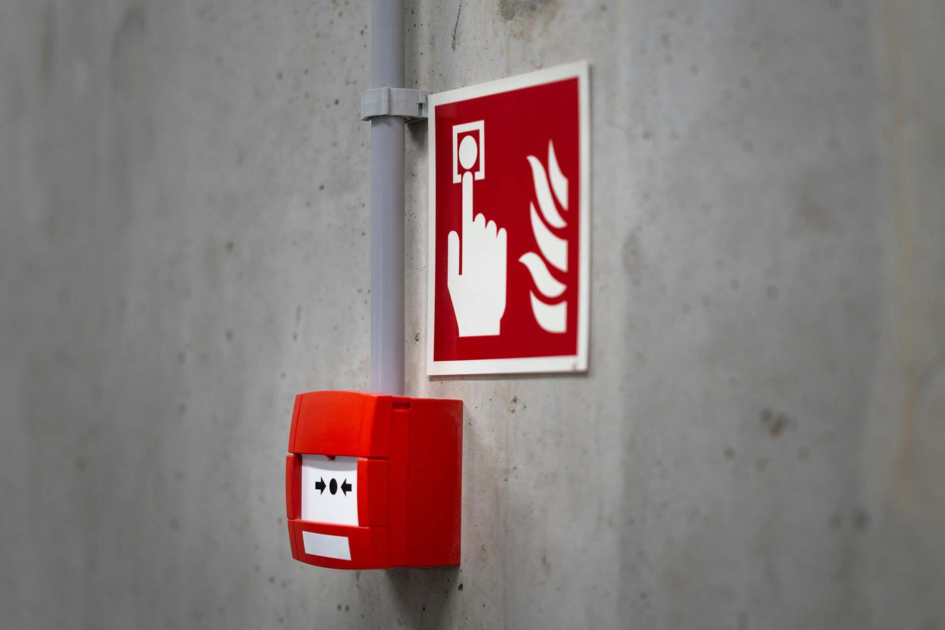 An image of a fire alarm and fire safety signage